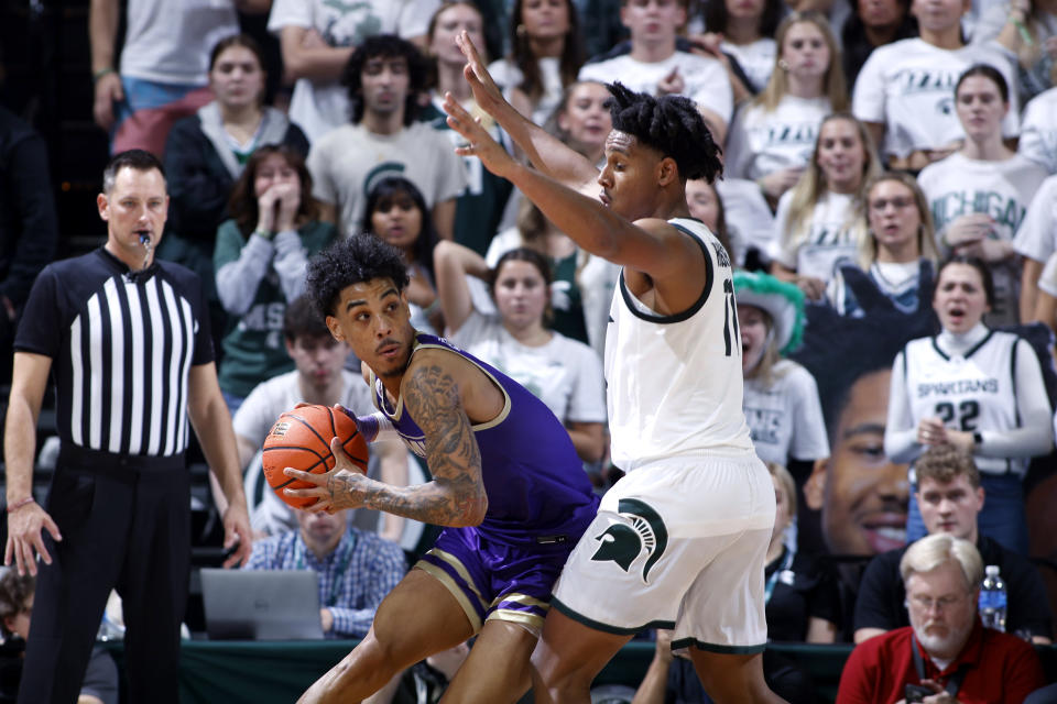 James Madison's Terrence Edwards Jr., left, looks to maneuver against Michigan State's A.J. Hoggard during the second half of an NCAA college basketball game, Monday, Nov. 6, 2023, in East Lansing, Mich. (AP Photo/Al Goldis)