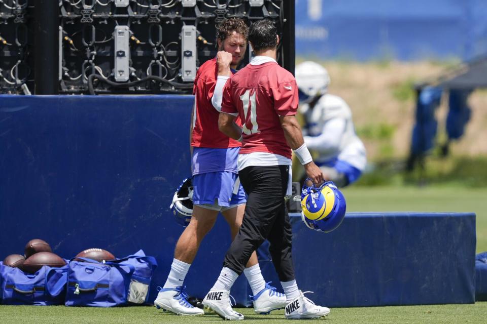 Rams quarterbacks Matthew Stafford, left, and Jimmy Garoppolo walk and talk during an organized team activity.