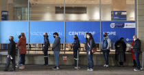 People queue at the Vaccination Centre of Hope at the Cape Town International Convention Centre in Cape Town, South Africa, Wednesday Aug. 4, 2021. Hitting its stride after a faltering start, South Africa's mass vaccination campaign gave jabs to 220,000 people a day last week and is accelerating toward the goal of 300,000 per day.(AP Photo/Nardus Engelbrecht)