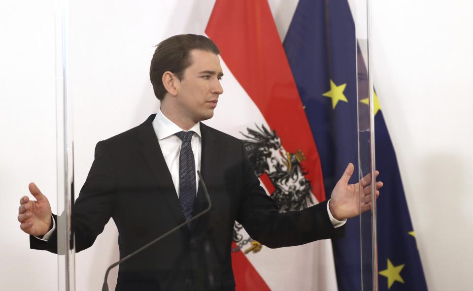 Austrian Chancellor Sebastian Kurz speakes behind plexiglass shields at a press conference at the federal chancellery in Vienna, Austria, Wednesday, Dec. 2, 2020. The Austrian government has moved to restrict freedom of movement for people, in an effort to slow the onset of the COVID-19 coronavirus. (AP Photo/Ronald Zak)