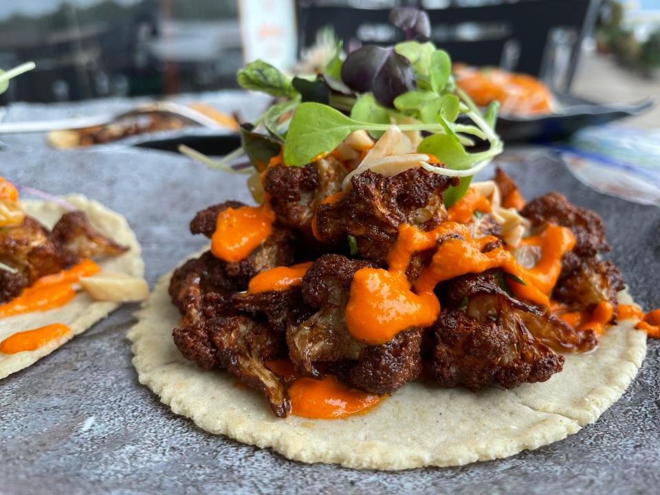 Cauliflower taco at Craft Taqueria in New City has roasted piquillo pepper romesco, toasted almonds, golden raisins and fresh herbs. Photographed August 2023