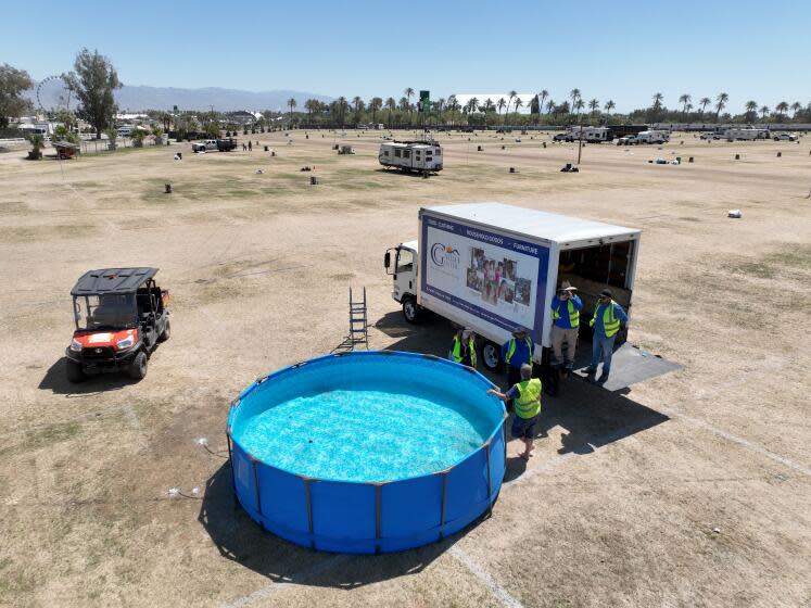 Indio, CA - April 29: Aerial view of crews draining a reusable swimming pool in The RV Resort area that will be loaded in a truck after the Stagecoach Festival that concluded Sunday at the Empire Polo Fields in Indio Monday, April 29, 2024. A lot of it gets collected and given to charitable organizations. Some common items are inflatable swimming pools, sleeping bags, chairs, coolers, etc. (Allen J. Schaben / Los Angeles Times)