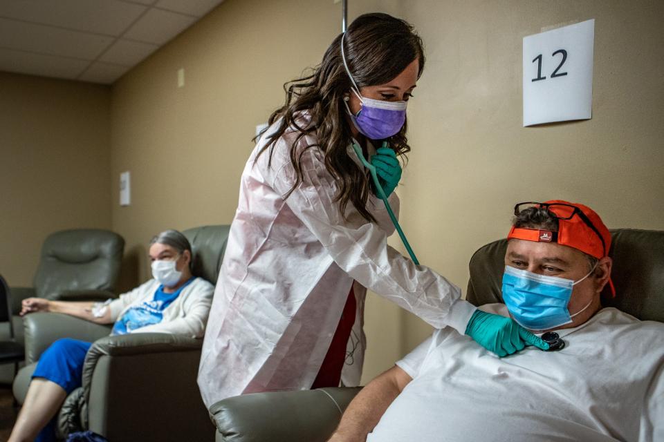 Nurse practitioner Katie Cornett  checks in on patients as they receive monoclonal antibody infusions for COVID-19 at the Primary Care Centers of Eastern Kentucky in Hazard on Sept. 20.