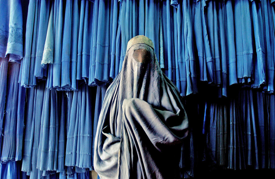 someone with a veil on in front of a blue background