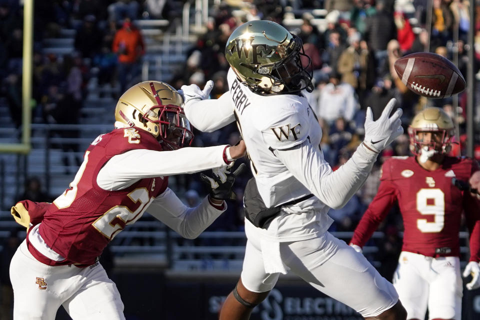 Wake Forest wide receiver A.T. Perry (9) can't haul in a pass ahead of Boston College defensive back Elijah Jones (20) during the second half of an NCAA college football game, Saturday, Nov. 27, 2021, in Boston. (AP Photo/Mary Schwalm)