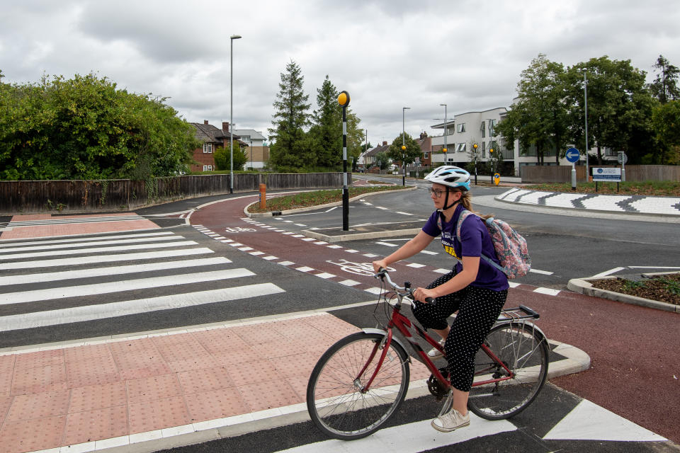 A cyclist uses the UK's first Dutch-style roundabout � which prioritises cyclists and pedestrians over motorists � after it opened in Fendon Road, Cambridge. The cost of the scheme, originally estimated at around GBP 800,000, has almost trebled to GBP 2.3m at the end of the project.