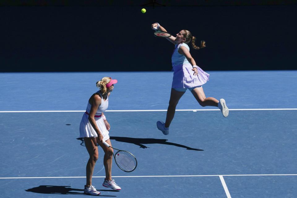 Jelena Ostapenko, right, of Latvia and Lyudmyla Kichenok of Ukraine in action against Hsieh Su-Wei of Taiwan and Elise Mertens of Belgium during the women's doubles final at the Australian Open tennis championships at Melbourne Park, in Melbourne, Australia, Sunday, Jan. 28, 2024. (AP Photo/Alessandra Tarantino)
