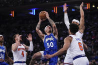 Orlando Magic's Cole Anthony (50) looks to shoot over New York Knicks' Quentin Grimes (6) and Duane Washington Jr. (4) during the first half of an NBA basketball game Monday, Jan. 15, 2024, in New York. (AP Photo/Frank Franklin II)