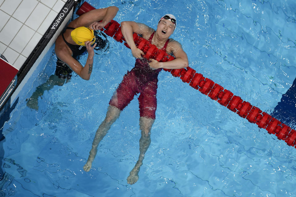 Margaret MacNeil, of Canada, right, reacts after winning the final of the women's 100-meter butterfly as Sarah Sjoestroem, of Sweden, looks on at the 2020 Summer Olympics, Monday, July 26, 2021, in Tokyo, Japan. (AP Photo/Morry Gash)