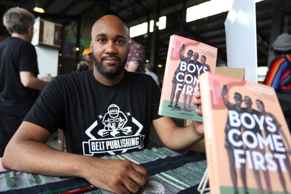 Author Aaron Foley with his book Boys Come First during the Detroit Book Fest at Eastern Market Sunday, July 17, 2022. 