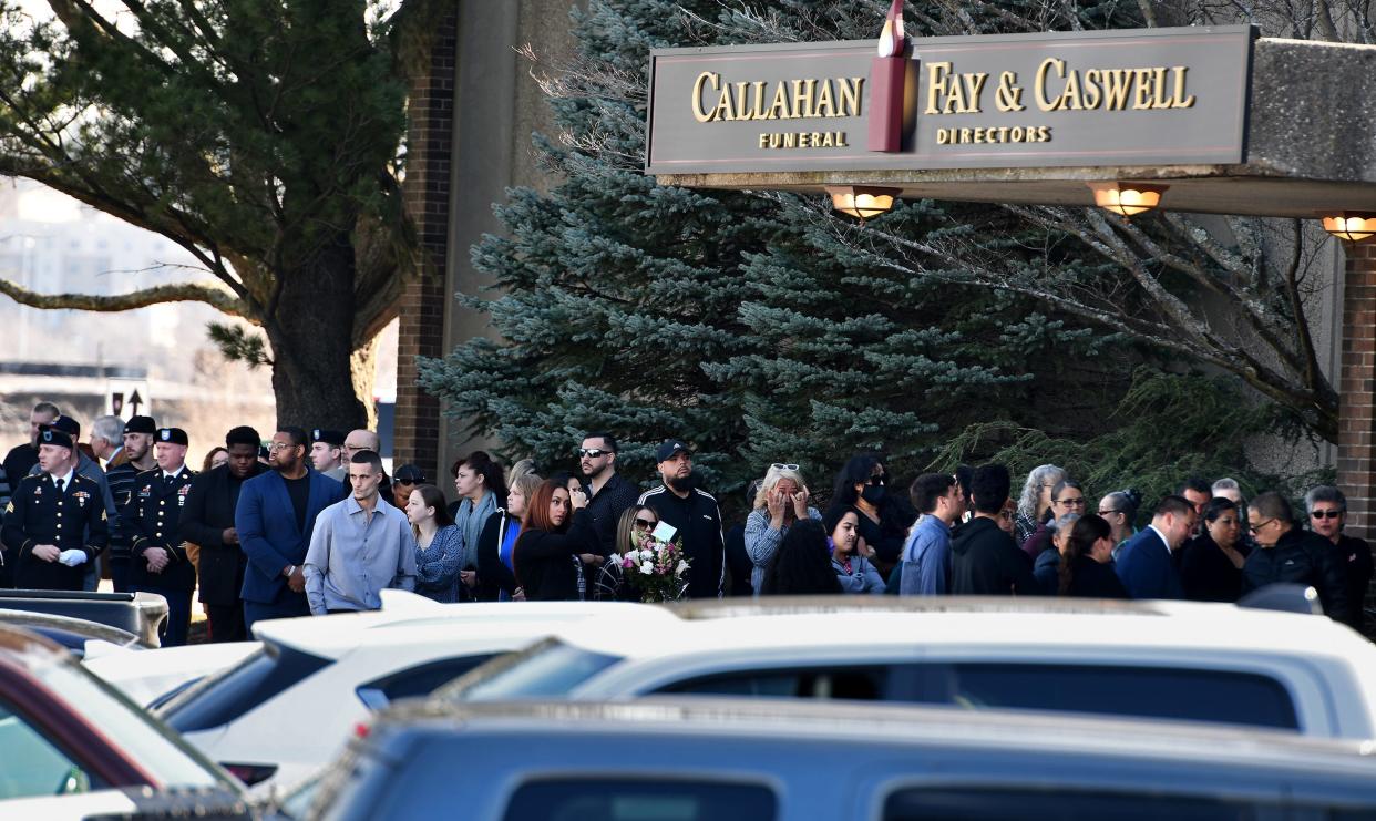 Mourners wait to enter Callahan Fay & Caswell Funeral Home for the wake of Chasity and Zella Nuñez Thursday.