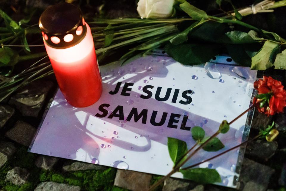 A candle and message placed at the site of a vigil to pay respect to beheaded French teacher Samuel Paty in front of the French embassy, in Berlin (EPA)