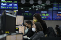 Currency traders watch monitors at the foreign exchange dealing room of the KEB Hana Bank headquarters in Seoul, South Korea, Tuesday, Jan. 25, 2022. Asian shares skidded Tuesday following a volatile day on Wall Street. Inflation-fighting measures from the Federal Reserve and the possibility of conflict between Russia and Ukraine are overhanging markets. (AP Photo/Ahn Young-joon)