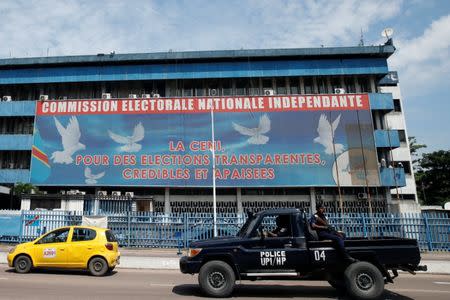 Congolese policemen drive past Congo's Independent National Electoral Commission (CENI) headquarters in Kinshasa, Democratic Republic of Congo, January 9, 2019. REUTERS/Baz Ratner