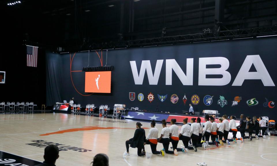 The entire Las Vegas Aces basketball team took a knee during the national anthem before a game last season in Palmetto, Fla. The stadium was empty because fans weren't allowed inside the WNBA bubble.