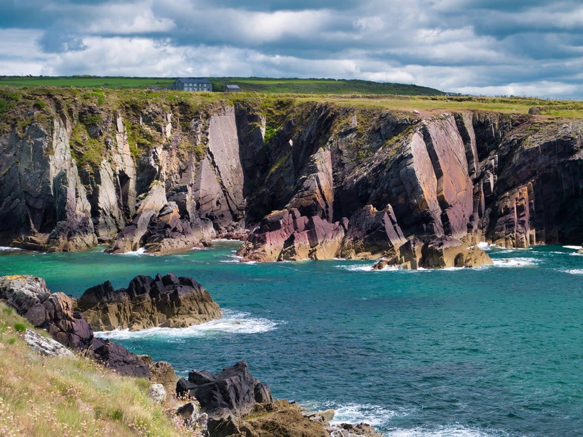 Leap across rocks along the Pembrokeshire coastal path on a coasteering trip  (Getty Images/iStockphoto)