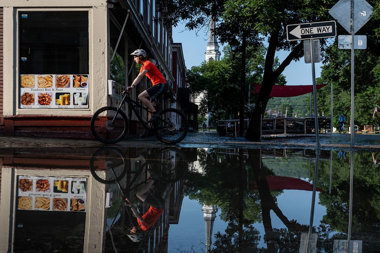 A person bikes around downtown once flood waters receded (Getty Images)