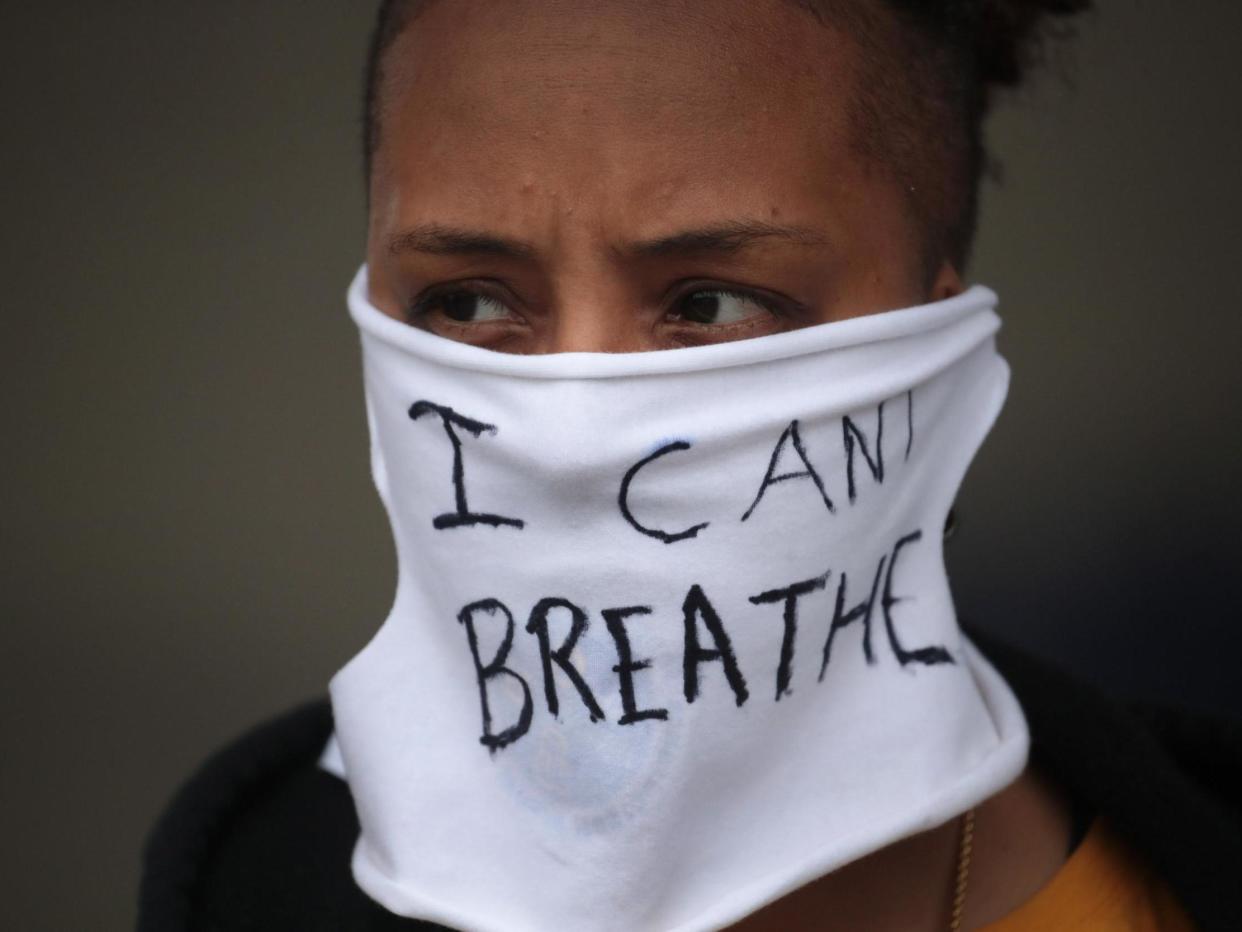 A person wears a mask that reads "I CAN'T BREATHE" as demonstrators continue to protest the death of George Floyd: (Getty Images)