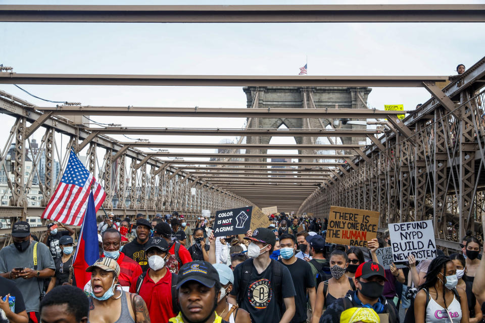 Protesters march on the Brooklyn Bridge after a rally in Cadman Plaza Park, Thursday, June 4, 2020, in New York. Protests continued following the death of George Floyd, who died after being restrained by Minneapolis police officers on May 25. (AP Photo/John Minchillo)