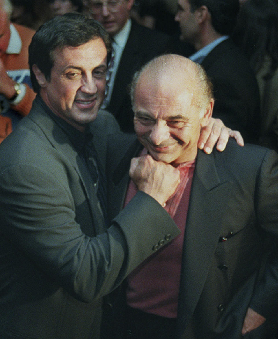 FILE - Sylvester Stallone, left, mugs with "Rocky" co-star Burt Young before a screening of the 1976 film to celebrate its 20th anniversary, Nov. 15, 1996, in Beverly Hills, Calif. Burt Young, the Oscar-nominated actor who played Paulie, the rough-hewn, mumbling-and-grumbling best friend, corner-man and brother-in-law to Sylvester Stallone in the “Rocky” franchise, has died. Young died Oct. 8, 2023 in Los Angeles. (AP Photo/Chris Pizzello, File)