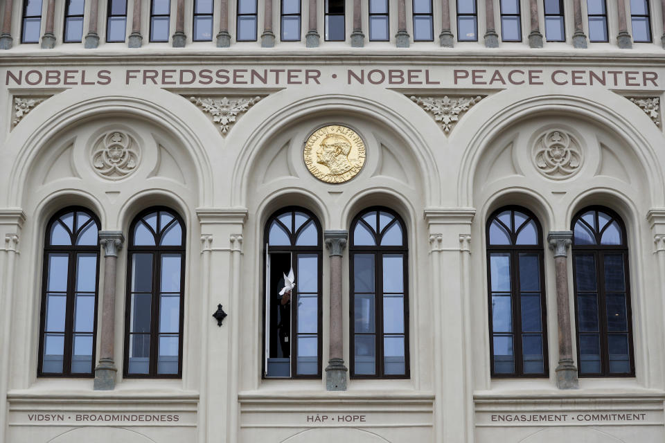 At 12.00 a dove symbolising peace flies from the window of the Nobel Peace Center in connection with the announcement of the new peace prize winner, in Oslo, Friday, Oct. 6, 2023. The Nobel Peace Prize 2023 was awarded to Narges Mohammadi for fighting oppression of women in Iran. (Frederik Ringnes/NTB Scanpix via AP)