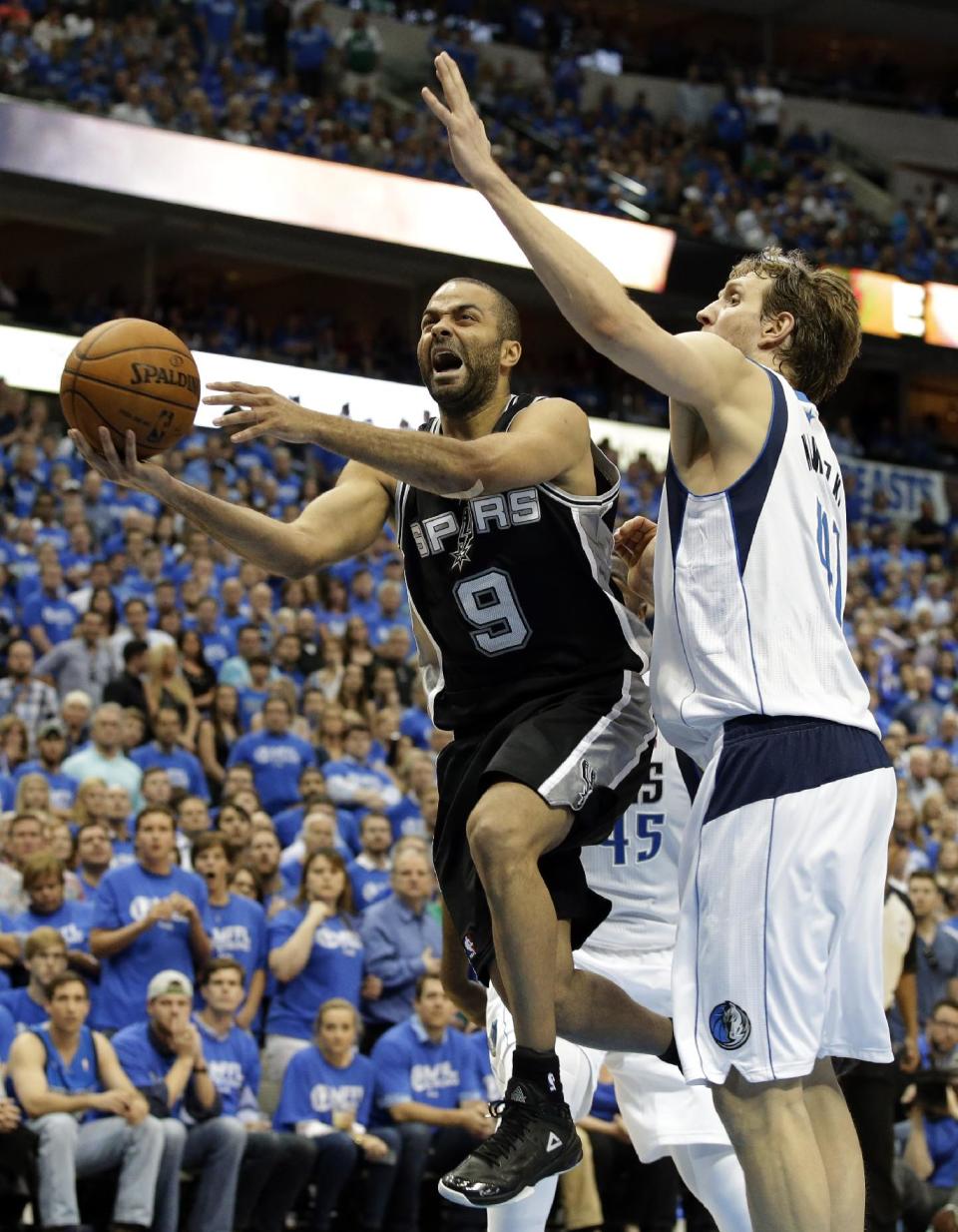 San Antonio Spurs' Tony Parker (9), of France, goes up for a score against Dallas Mavericks' Dirk Nowitzki, of Germany, late in the second half of Game 6 of an NBA basketball first-round playoff series on Friday, May 2, 2014, in Dallas. The Mavericks won 113-111. (AP Photo/Tony Gutierrez)