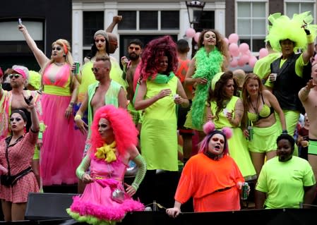 Participants cruise the canals in boats during the annual gay pride parade in Amsterdam