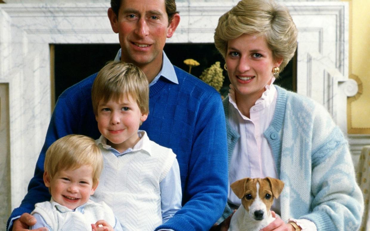 Prince Charles, Prince of Wales and Diana, Princess of Wales, at home in Kensington Palace with a young Prince William and an even younger Prince Harry - Tim Graham/Getty Images