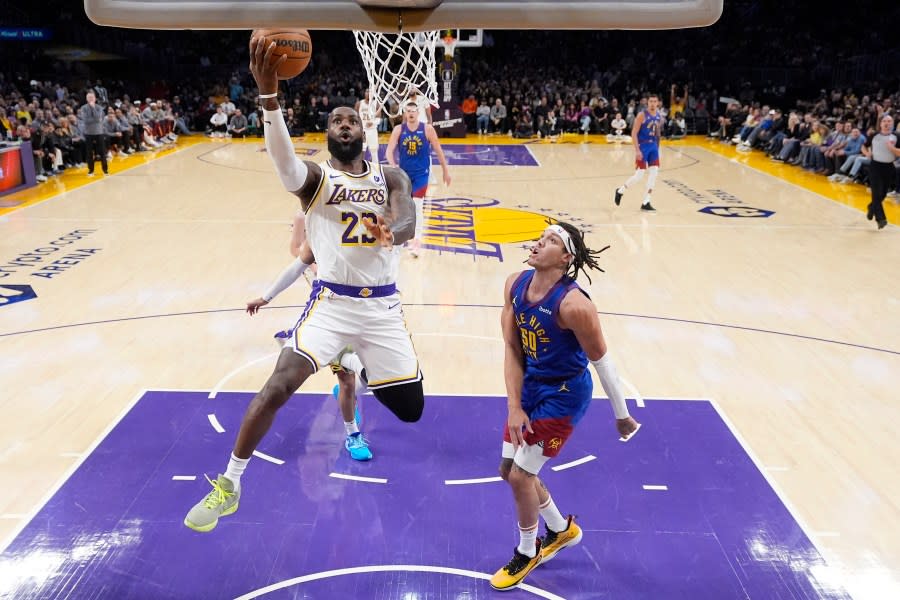 Los Angeles Lakers forward LeBron James, left, shoots as Denver Nuggets forward Aaron Gordon defends during the first half of an NBA basketball game Saturday, March 2, 2024, in Los Angeles. (AP Photo/Mark J. Terrill)