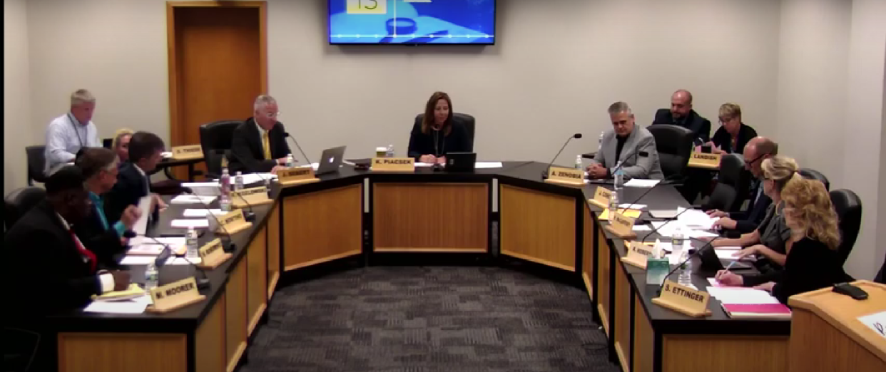 This screenshot shows the Waukesha School Board meeting July 13.