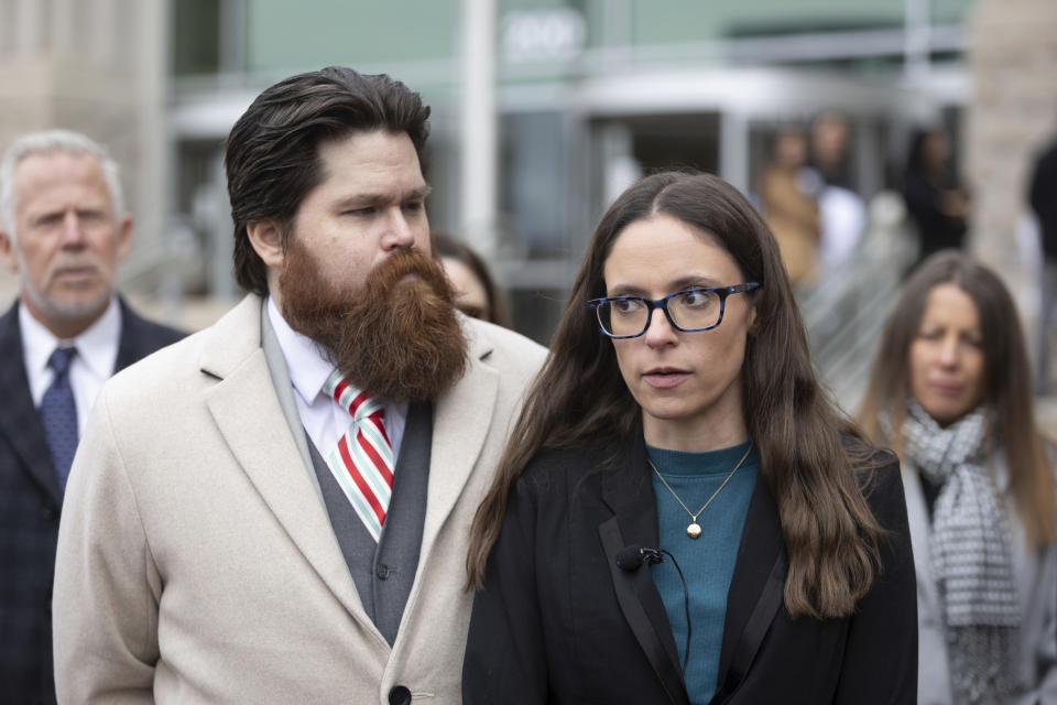 Jennifer Adkins and husband, John, from Caldwell, Idaho talk to the media outside the Ada County Courthouse, Thursday, Dec. 14, 2023 in Boise, Idaho. The two are plaintiffs in a case concerning access to abortive care in Idaho. An attorney for Idaho asked a judge on Thursday to throw out a lawsuit seeking clarity about the medical exemptions to the state's broad abortion bans, saying it was based on hypothetical situations rather than current facts. (AP Photo/Kyle Green)