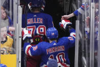 New York Rangers left wing Artemi Panarin (10) greets people as he step off the ice after they defeated the Boston Bruins in an NHL hockey game, Thursday, March 21, 2024, in Boston. (AP Photo/Steven Senne)