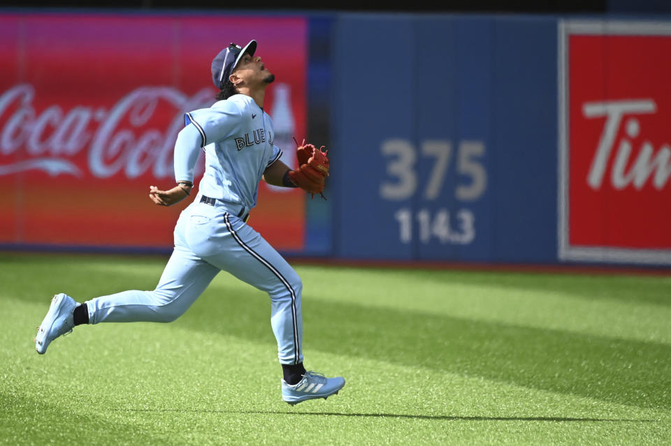 Toronto Blue Jays second baseman Santiago Espinal tracks a pop fly off the bat of Cleveland Guardians' Steven Kwan in fifth-inning baseball game action in Toronto, Saturday, Aug. 13, 2022. (Jon Blacker/The Canadian Press via AP)