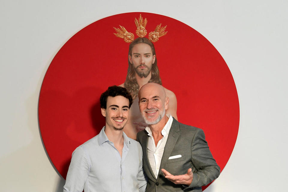 Artist Salustiano Garcia poses with his son and model Horacio in front of the painting. (Cristina Quicler / AFP - Getty Images)