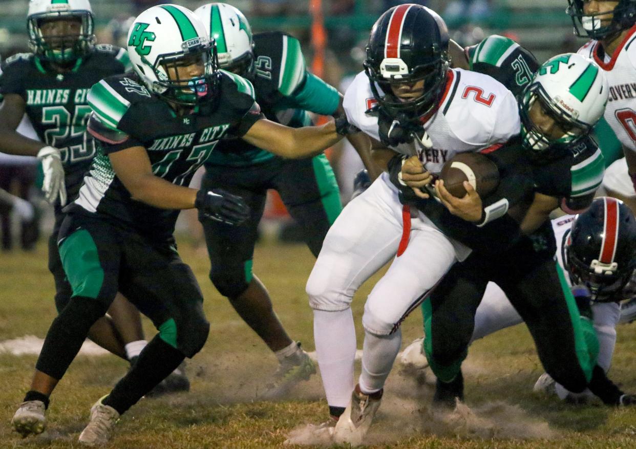 Brandon Ashlock is tackle by Haines City's Jadon Freeman (12) as Caleb Lugo (47) closes in on Friday night at Joe Stangry Stadium.