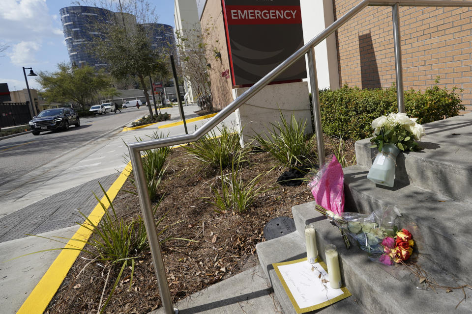 Flowers and notes were left at a small makeshift memorial in front of the emergency room at Orlando Regional Medical Center Thursday, Feb. 23, 2023, in Orlando, Fla. A TV journalist and a child were shot and killed yesterday and several others were injured at a scene where a woman was found murdered earlier in the day. (AP Photo/John Raoux)