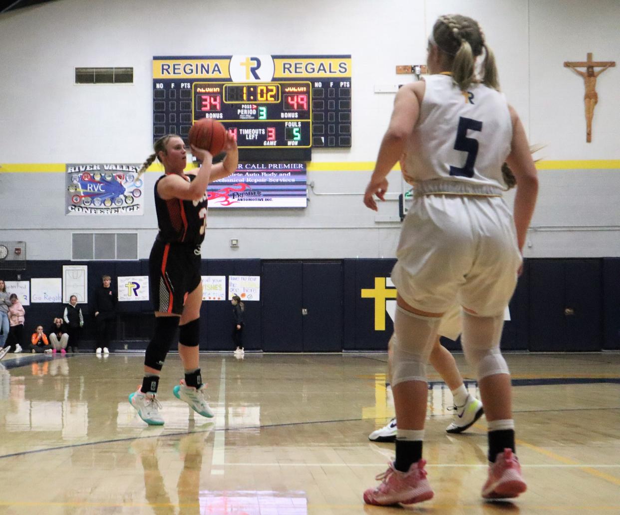 Solon's Hilary Wilson (32) attempts a three-pointer against Iowa City Regina on Saturday.