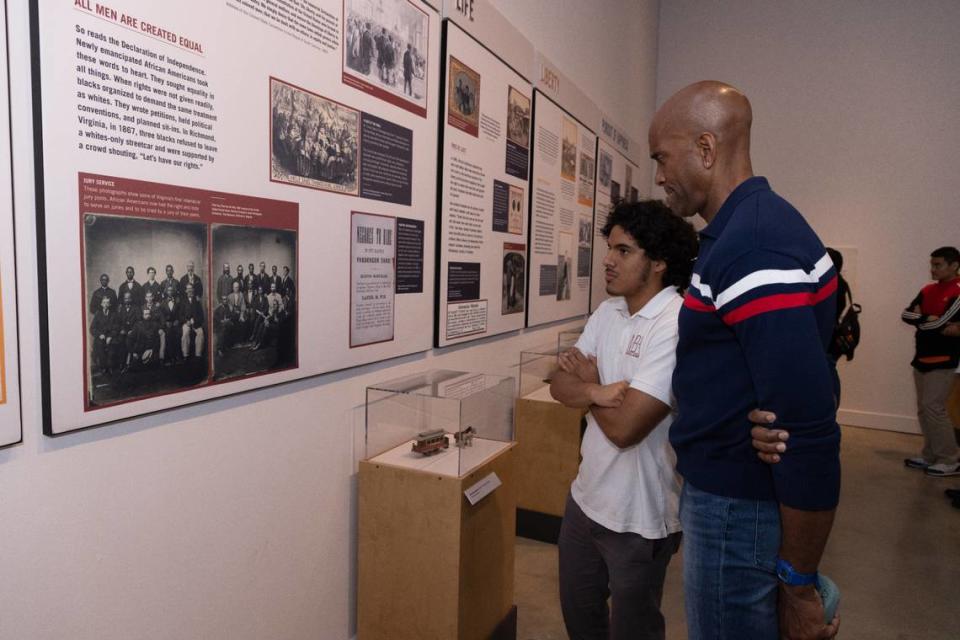 Michael McCullough, the Miami Heat’s executive vice president and chief marketing officer, and a Mater Brickell Academy student look at a Black history exhibit. Known as the Heat’s “brand architect,” McCullough is responsible for crafting the unique identity of one of the NBA’s most successful franchises since the turn of the century.