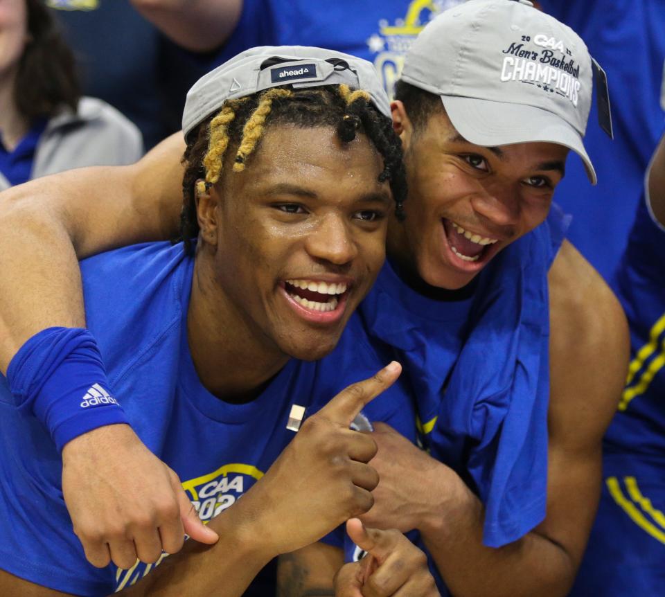 Delaware's Jyare Davis (left) and Jameer Nelson, Jr., pose for photos after the Blue Hens' 59-55 win in the Colonial Athletic Association championship against UNCW at the Entertainment & Sports Arena in Washington, D.C., Tuesday, March 8, 2022.