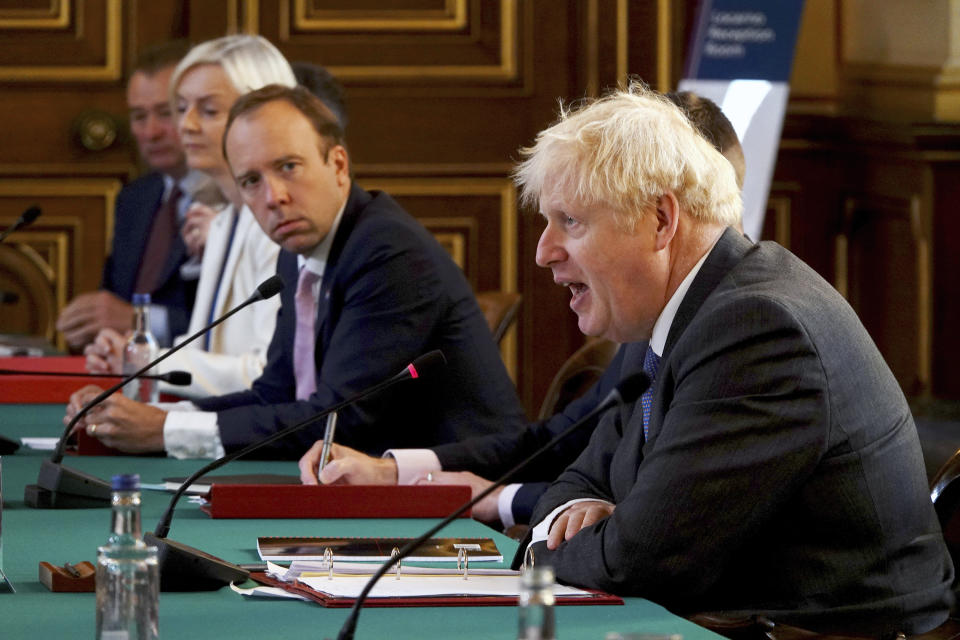 Britain's Prime Minister Boris Johnson, right, chairs a socially distanced government Cabinet meeting at the Foreign and Commonwealth Office (FCO) in London, Tuesday Sept. 15, 2020. Health Secretary Mat Hancock, centre, and International Trade Secretary Liz Truss, 2nd left. (Jonathan Buckmaster/Pool via AP)
