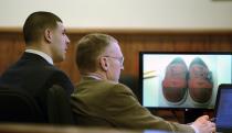 Former New England Patriots football player Aaron Hernandez (L) and his attorney Charles Rankin look at an exhibit on a monitor during his murder trial in Fall River, Massachusetts March 13, 2015. The shoes are Creative Recreation Red Herringbone shoes, allegedly worn by Ernest Wallace the night of the Odin Lloyd shooting. Hernandez is charged with killing semi-professional football player Odin Lloyd. REUTERS/Ted Fitzgerald/Pool (UNITED STATES - Tags: CRIME LAW SPORT FOOTBALL)