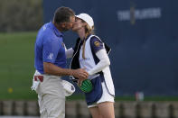 Lee Westwood, of England, kisses his fiancee and caddie, Helen Storey, on the 18th green after the third round of The Players Championship golf tournament Saturday, March 13, 2021, in Ponte Vedra Beach, Fla.(AP Photo/Gerald Herbert)