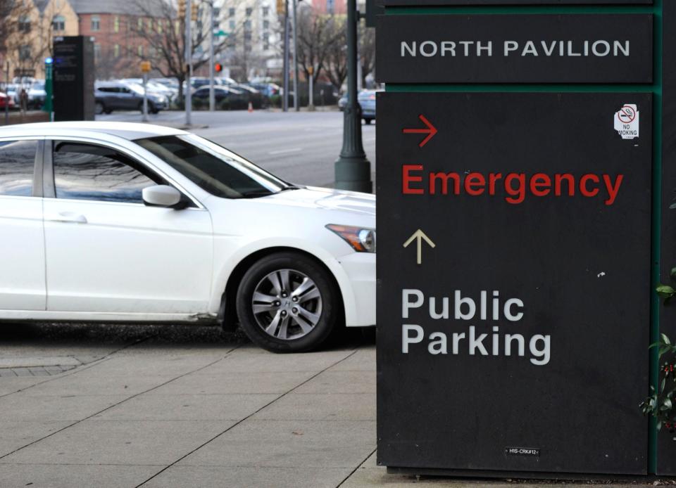 A car pulls into the emergency room entrance at UAB Hospital in Birmingham on Jan. 5, 2022. With its emergency department overwhelmed by COVID-19 patients and normal health problems, including trauma injuries and heart attacks, the hospital issued what it called an "urgent" request for people to go elsewhere for COVID-19 tests or minor symptoms, or to simply stay home for all but true emergencies.