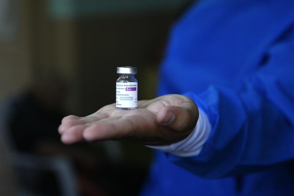 A nurse holds an AstraZeneca COVID-19 vial at "Santo Domingo" senior home Asuncion, Paraguay, Saturday, April 10, 2021. (AP Photo/Jorge Saenz)