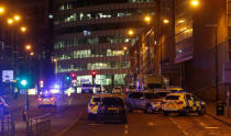 Vehicles are seen near a police cordon outside the Manchester Arena, where U.S. singer Ariana Grande had been performing, in Manchester, northern England, Britain, May 23, 2017. REUTERS/Andrew Yates