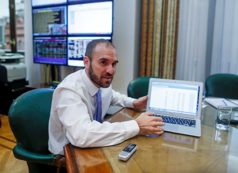 Argentine Economy Minister Martin Guzman shows a graphic during an interview with Reuters, in Buenos Aires