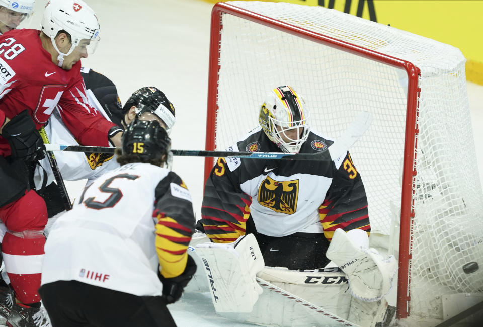 Mathias Niederberger of Germany blocks a shot during the Ice Hockey World Championship quaterfinal match between Switzerland and Germany at the Olympic Sports Center in Riga, Latvia, Thursday, June 3, 2021. (AP Photo/Oksana Dzadan)