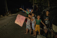 ALCALA, PHILIPPINES - NOVEMBER 16: Residents whose homes were destroyed by Typhoon Vamco beg alms from passing motorists as they stay in makeshift tents along a highway on November 16, 2020 in Alcala, Cagayan province, Philippines. The Cagayan Valley region in northern Philippines saw its worst flooding in 48 years after a dam released massive amounts of rainwater brought about by Typhoon Vamco. The country continues to reel from the widespread destruction caused by this year's deadliest cyclone which has killed at least 67 people. (Photo by Ezra Acayan/Getty Images)