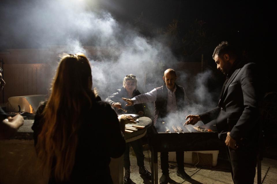 Roxanne Mirzaee and Ben Shaool cook kabobs at a birthday party in Beverly Hills, Calif. on Sunday, Jan. 5, 2020.