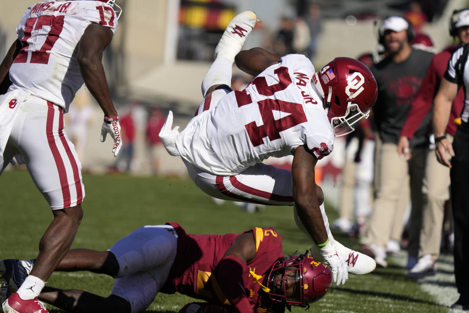 Oklahoma running back Marcus Major (24) is tackled by Iowa State defensive back T.J. Tampa (2) during the first half of an NCAA college football game, Saturday, Oct. 29, 2022, in Ames, Iowa. (AP Photo/Charlie Neibergall)